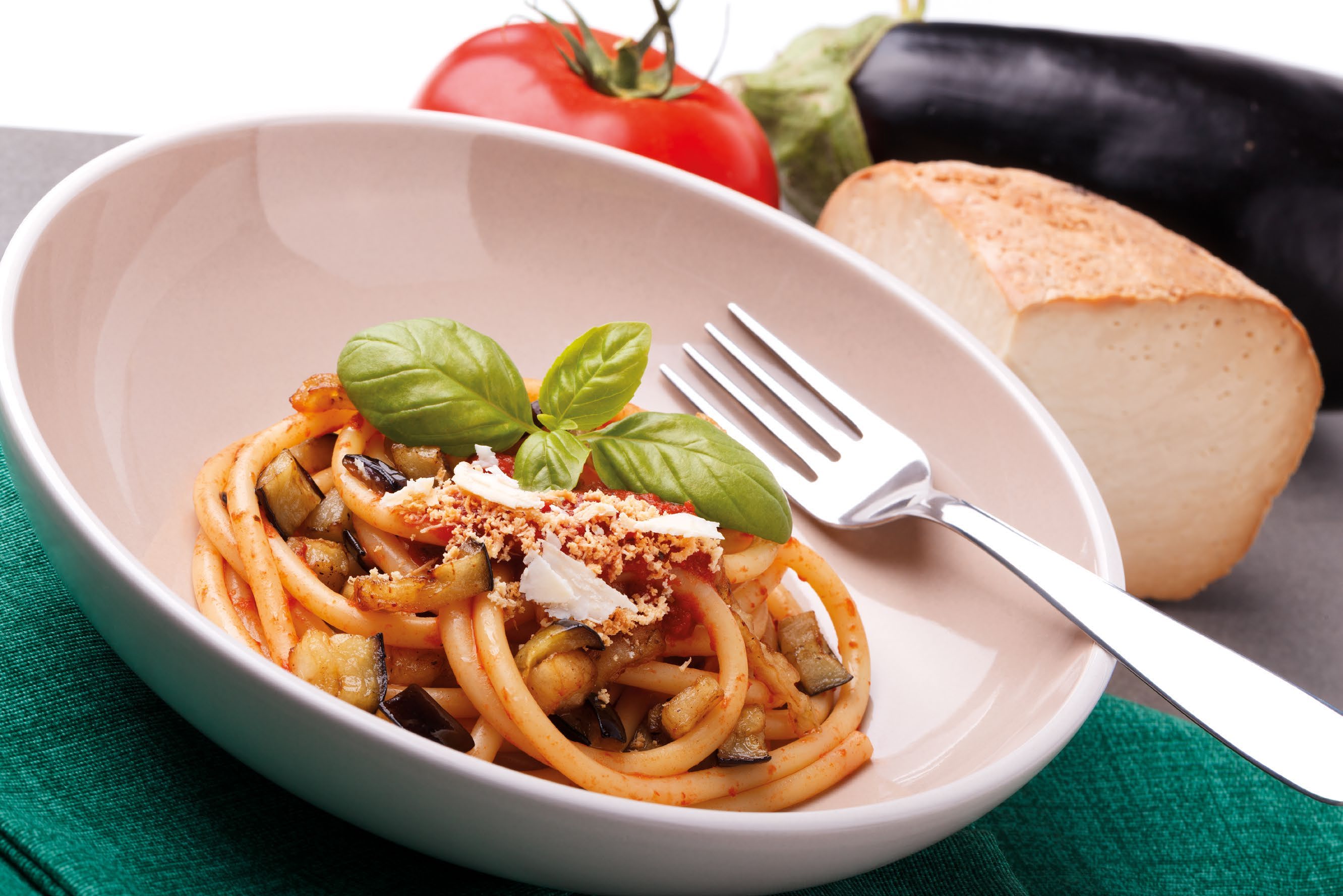 Italian pasta with eggplant, tomato, basil and grated cheese